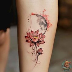 a woman's leg with a flower and moon tattoo on the side of her thigh