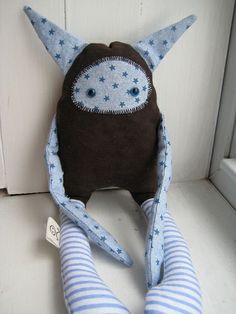 a stuffed animal with blue and white striped socks