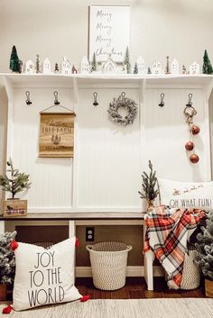 christmas decorations are displayed on the wall above a bench