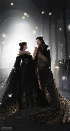 two women dressed in black and gold standing next to each other with lights on them