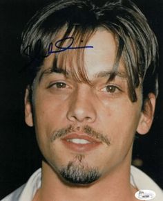 an autographed photograph of a man with brown hair