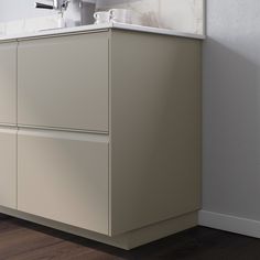 a bathroom sink sitting under a mirror next to a white cabinet with two drawers and a faucet