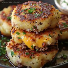 three cheeseburger patties stacked on top of each other with sauce and parsley