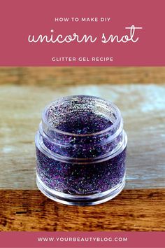 a small jar filled with glitter on top of a wooden table next to the words how to make diy unicorn snot