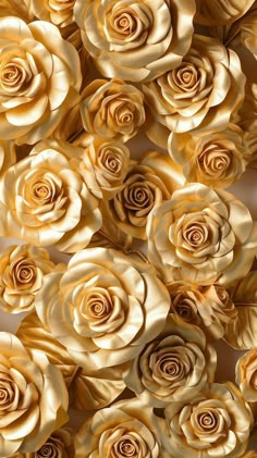 many gold roses are arranged in rows on the wall, as if they were made out of paper