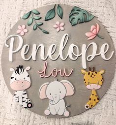 a metal sign that says penelope love with animals and flowers on the front