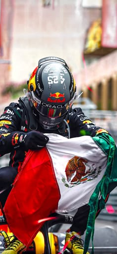 a man riding on the back of a motorcycle holding a flag