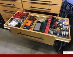 the drawers are full of tools and other work equipment in it's storage compartment