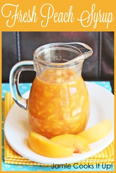 a glass pitcher filled with peach syrup on top of a white plate