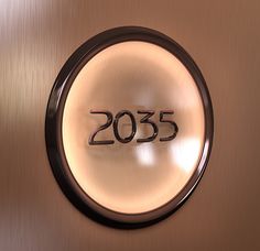 a metal plaque with the number 2055 on it