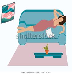 a woman is lying on the couch and watching tv