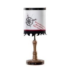 a table lamp with a wooden base and a white shade on the bottom that has a red, black and white design