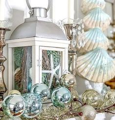 a white lantern sitting on top of a mantle filled with ornaments