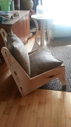 a wooden rocking chair sitting on top of a hard wood floor