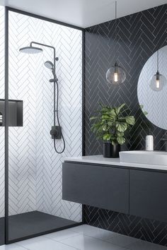 a modern bathroom with black and white tiles on the walls, shower head, sink and mirror