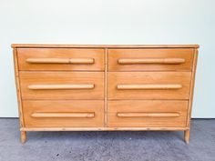 a wooden dresser sitting on top of a cement floor