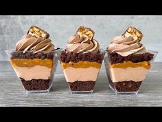 three desserts in small glass cups with frosting and toppings on the top