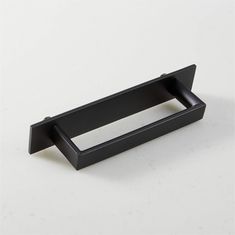 a black drawer handle on a white surface