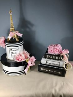 two cakes decorated with pink flowers and the eiffel tower