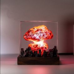 a glass block with an image of a mushroom in the center and buildings behind it