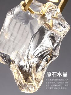 an image of a glass object that is hanging in the air with gold hardware on it