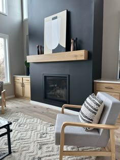 a living room with a chair and fireplace