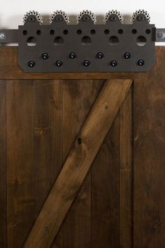 a close up of a wooden door with metal bars on the top and bottom part