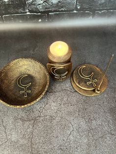 three small bowls and two candles on a table