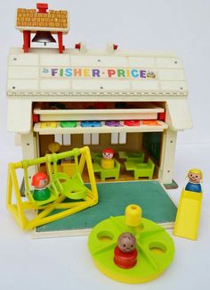 there is a toy fisher price store with toys in front and on the ground