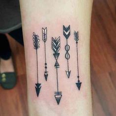 an arrow tattoo on the wrist with arrows in different colors and shapes, all drawn by hand