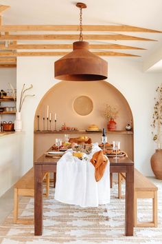 a dining room table with an oven in the back ground and food on top of it