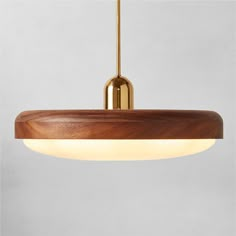 a wooden light fixture hanging from a ceiling