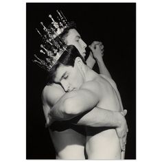 a black and white photo of a man hugging a woman with a crown on his head