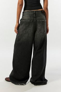 Statement BDG jeans in a column silhouette. Designed with an ultra-wide leg in a low-rise that sits at the hips and raw hems that skim the floor for an edgier vibe. Exclusively at Urban Outfitters. Features BDG Anika ultra-wide leg column jeans Low rise baggy jeans Lightweight soft denim Low rise waist 5 pocket styling Full length Raw hems UO exclusive Content + Care 42% Cotton, 20% recycled cotton, 38% Tencel Machine wash Imported Size + Fit Low rise Ultra-wide column leg Full length Model in Black is 5’8" and wearing size 28 Measurements taken from size 28 Waist: 30" Inseam: 30" | BDG Anika Ultra-Wide Leg Column Jean in Black, Women's at Urban Outfitters Very Oversized Jeans, Womens Baggy Pants, Baggy Jeans Where To Buy, Black Jnco Jeans, Lowrise Baggy Jeans, Dark Wash Wide Leg Jeans, Junco Jeans, How To Style Black Jeans, Baggy Black Jeans Outfit