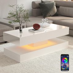 a living room with a couch, coffee table and cell phone