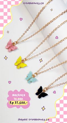 four necklaces with different colored butterflies on them