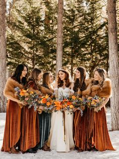 a group of women standing next to each other in the snow