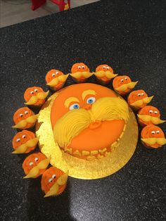 there is a cake that has been decorated to look like an orange man with many eyes