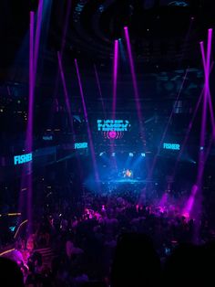 the stage is lit up with purple and blue lights