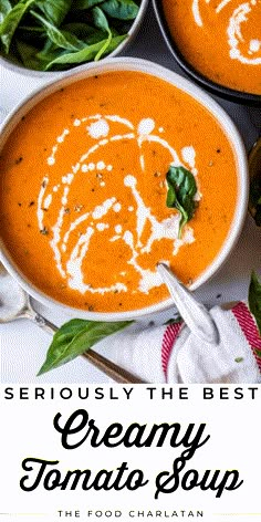 two bowls of creamy tomato soup with spinach on the side and text overlay reads seriously the best creamy tomato soup