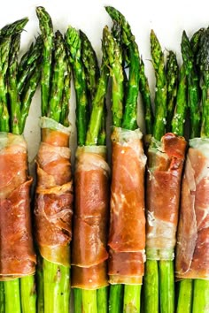 asparagus wrapped in bacon are lined up