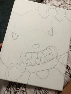 someone is holding up a drawing of a bear with teeth and fangs on it's face