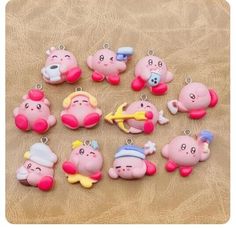 twelve little pig keychains are shown on a table