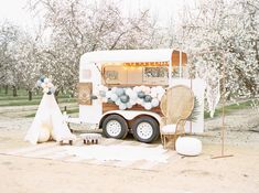 an ice cream truck is decorated with balloons and decorations for a wedding reception in the desert