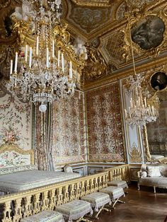 an ornately decorated bedroom with chandelier and bed