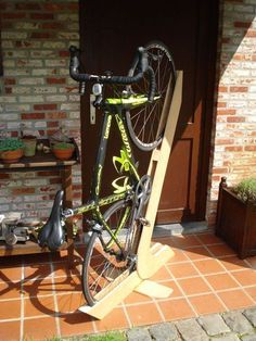 a bicycle is propped up on a wooden stand