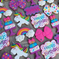 decorated cookies with unicorns, rainbows and hearts on them for a birthday party