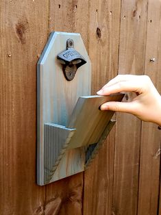 someone is opening the door to their house with an old style key lock on it