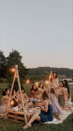 a group of women sitting around a picnic table