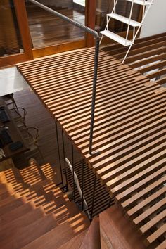 a chair sitting on top of a wooden floor next to a metal railing and stairs